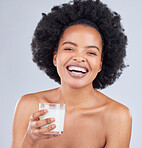 Happy woman, portrait and drink milk in studio for healthy skin, diet and calcium on white background. African model, dairy smoothie and glass of vanilla milkshake for nutrition, protein and beauty 