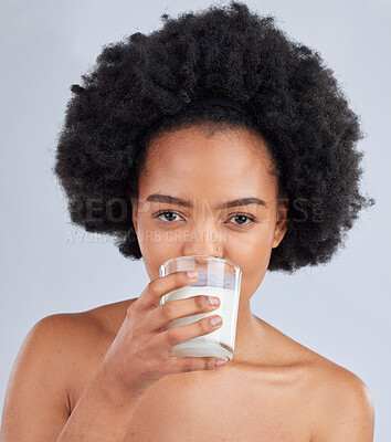 Buy stock photo Woman, portrait and drink milk in studio for healthy skin, diet and calcium on white background. Face of african model, dairy smoothie or glass of vanilla milkshake for nutrition, wellness and beauty