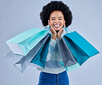 Portrait, woman and shopping bag on studio background for fashion, happy retail deal and financial freedom. Excited african customer, gift and discount present from boutique, store or sales promotion