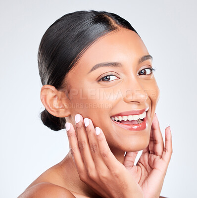Buy stock photo Portrait, happy woman and touch face in studio for pride in skincare, aesthetic glow or healthy dermatology on white background. Young indian model, natural beauty and smile for clean facial cosmetic