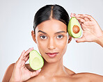 Portrait, avocado and woman with natural beauty, facial and eco friendly skincare isolated on white background. Wellness, dermatology and vegan cosmetics product with glow, shine and green in studio