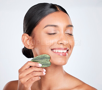 Buy stock photo Woman, face and gua sha, beauty and tools with jade stone for natural skincare isolated on white background. Facial massage, facelift and grooming with skin glow, dermatology and wellness in studio