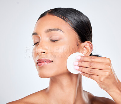 Buy stock photo Skincare, beauty and woman with cotton pad on face for natural glow and cosmetics in studio. Dermatology, eyes closed and smile of person with facial product for healthy skin on white background
