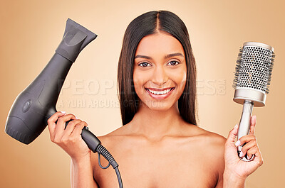 Buy stock photo Portrait, brush and hairdryer for haircare on a studio background for styling, grooming or a salon. Happy, ready and an Indian person or model with gear for drying a hairstyle or for a treatment