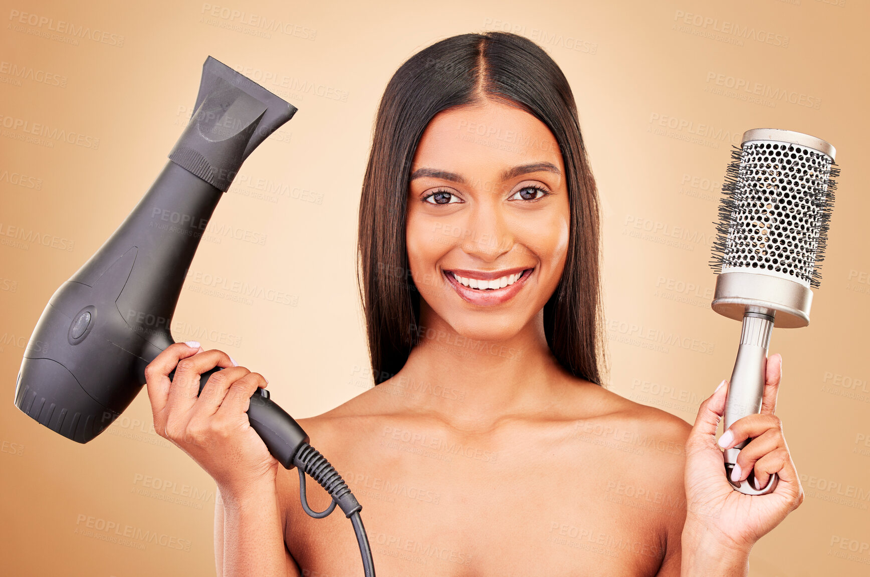 Buy stock photo Portrait, brush and hairdryer for haircare on a studio background for styling, grooming or a salon. Happy, ready and an Indian person or model with gear for drying a hairstyle or for a treatment