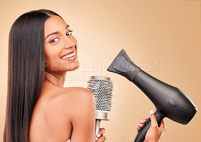 Buy stock photo Woman, smile and hair with dryer and brush for beauty and cosmetics tools in happy portrait on studio background. Heat treatment, keratin and wellness with straight hairstyle, salon care and growth
