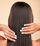 Hair, beauty and woman in a studio for shiny, long and clean hairstyle with salon treatment. Texture, health and back of female model with shampoo routine for haircut maintenance by brown background.