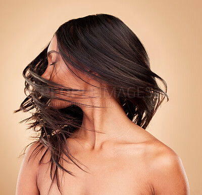 Buy stock photo Hair, beauty and woman shake head in studio isolated on a brown background. Hairstyle care, natural cosmetics and model in salon treatment for texture growth, health or wellness aesthetic with wind