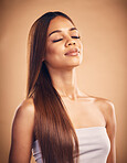 Face, hair and shampoo with a natural woman in studio on a brown background for keratin treatment. Beauty, glow and confident with a happy young model at the salon for growth or aesthetic haircare