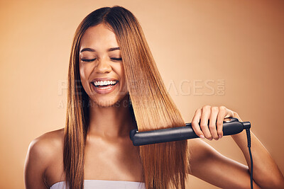 Buy stock photo Hair straightener, happy and woman in studio for beauty, cosmetics or appliance. Model person laugh on brown background for funny heat treatment, healthy results and hairdresser or salon flat iron