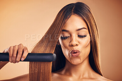 Buy stock photo Excited, hair straightener and a woman in studio for beauty, cosmetics or appliance. Aesthetic model on brown background for wow heat treatment, healthy results and hairdresser or salon flat iron
