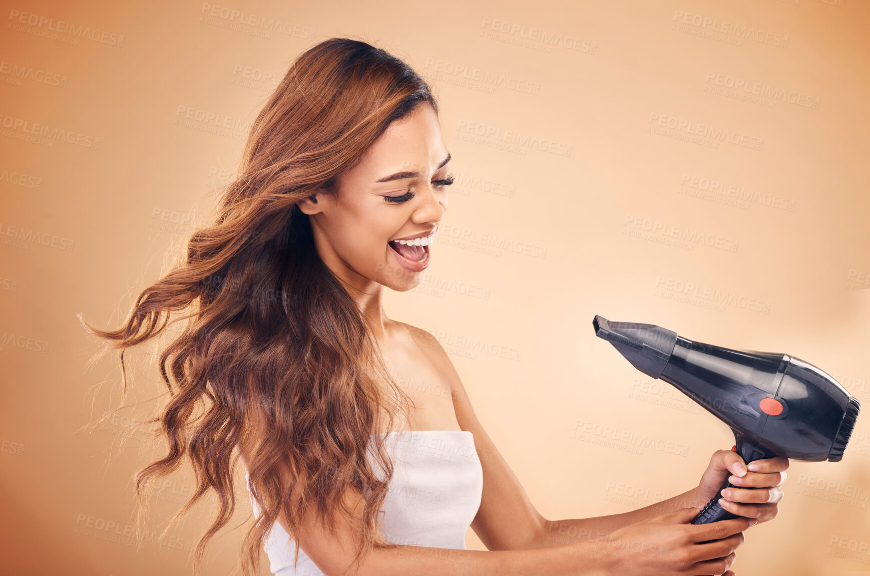 Buy stock photo Hair dryer, wind and a woman in studio for beauty, cosmetics and shine. Excited aesthetic model person on brown background for heat treatment, healthy results and hairdresser or salon blow out mockup