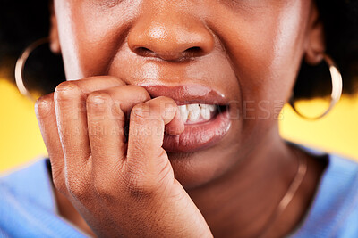 Buy stock photo Closeup, woman and biting hands in anxiety, nervous or mental health disorder against a yellow background. Mouth of anxious female person in stress, breakdown or issues and problems in bad habit