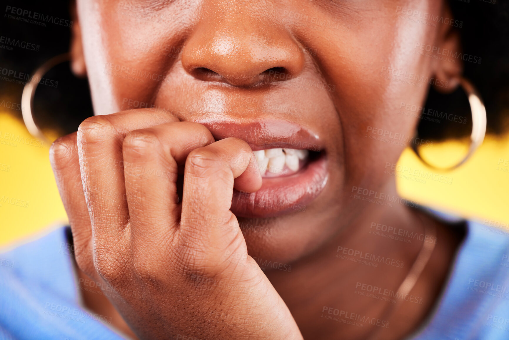 Buy stock photo Closeup, woman and biting hands in anxiety, nervous or mental health disorder against a yellow background. Mouth of anxious female person in stress, breakdown or issues and problems in bad habit