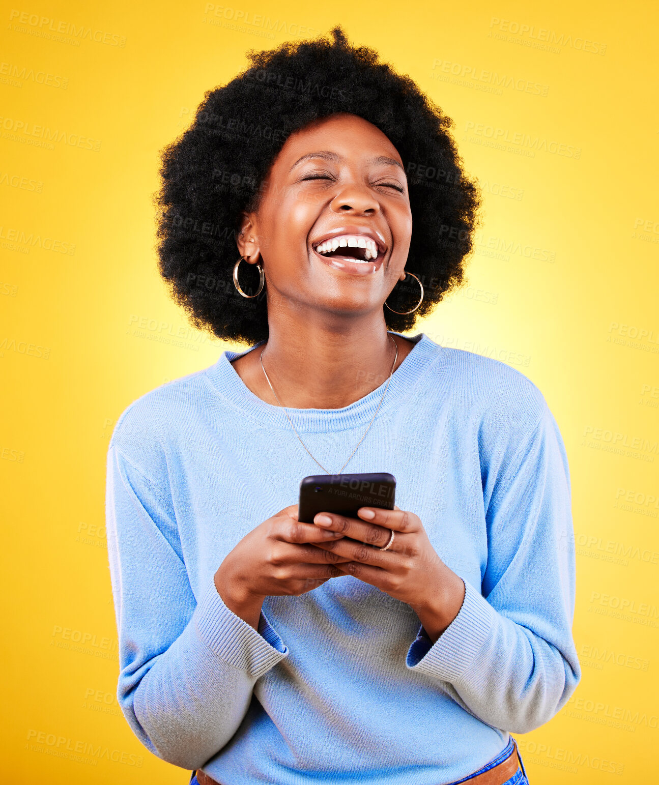 Buy stock photo Woman, laugh and typing on smartphone in studio, reading funny social media post and mobile news on yellow background. Happy african model, cellphone and joke of meme, multimedia notification or tech