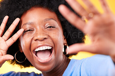 Buy stock photo Hands, excited and portrait of a black woman on a yellow background for creativity or freedom. Happy, face and an African girl with a gesture for photography, aesthetic or smile on a studio backdrop