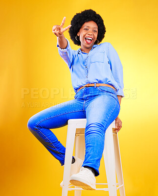 Buy stock photo Black woman, peace and sign with hands on chair in studio, yellow background or natural happiness with casual fashion and style. African, gen z or model smile and relax for creative, mockup or space