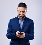 Phone, smile and businessman in studio typing text message on social media, mobile app or the internet. Happy, technology and professional male lawyer scroll online with cellphone by white background