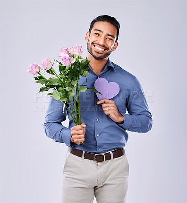 Purple heart, portrait and asian man with roses in studio for thank you, gift or care on grey background. Paper, frame and Japanese male model with flower, bouquet or offer, love or valentines day