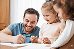 Homework, drawing and father with children in home for creative learning, education and development. Happy family, parents and dad with kids writing on paper for fun, lesson and teaching with color