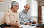 Budget, documents and senior couple with laptop planning financial investments, mortgage or tax papers. Elderly woman speaking of bills, debt and pension fund on bank statement to an old man at home 