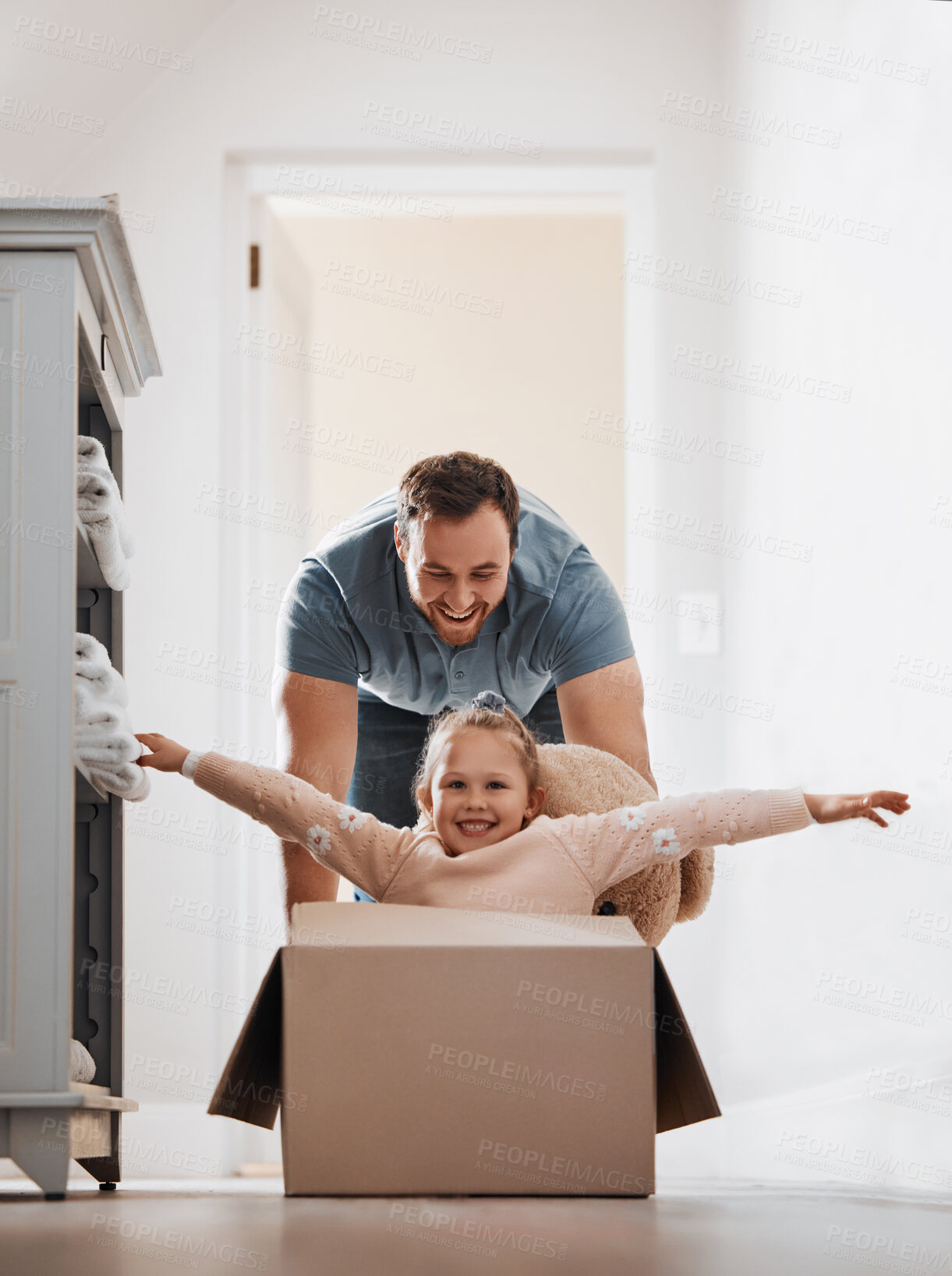 Buy stock photo Kid, father and pushing box in new house playing games or race with speed for bond, love or happiness. Dad, playful or excited child in cardboard with support, smile or trust on floor in family home