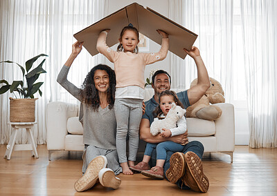 Buy stock photo Parents, children and cardboard roof in portrait, smile or excited for security, real estate or fresh start in family home. Mother, dad and kids on floor, box and happy together for support in house