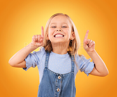 Buy stock photo Child, happy portrait and pointing up in studio for advertising, announcement or promotion. Excited young girl kid on a orange background for hand gesture, sale or sign for attention or marketing