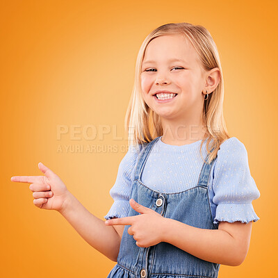 Buy stock photo Happy, portrait and child with finger gun in studio for advertising announcement or promotion. Young girl kid on orange background for pointing or hand sign for direction, attention or excited smile