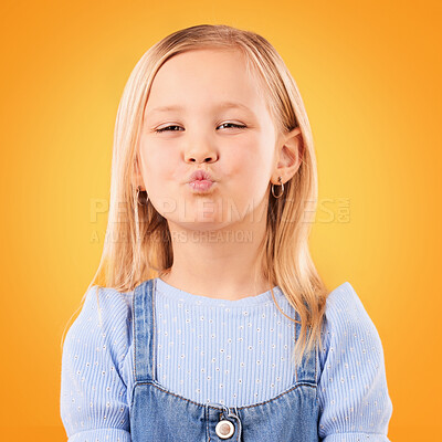 Buy stock photo Happy, pout and portrait of girl on orange background with happiness, joy and excited in studio. Confidence, childhood and face of young, adorable and cute child with kiss emoji facial expression