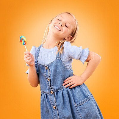 Buy stock photo Happy, lollipop and girl child with candy, hungry for dessert  
and isolated on an orange background in studio. Smile, sweets and young kid with sugar, unhealthy food and eating confectionery treats