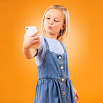 Kiss, selfie or child in studio with confidence or mockup space for photograph memory on web. Fashion, orange background or young girl taking pictures online on a social media app to post on internet