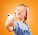 Kiss, selfie or face of kid in studio with confidence or mockup space in photograph memory. Web, orange background or young girl taking fun pictures online on a social media app to post on internet