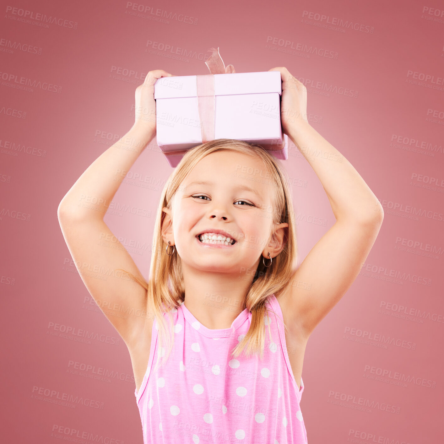 Buy stock photo Gift, present and child with box on head for birthday, holiday or happy celebration. Portrait of excited girl on a pink background for surprise, giveaway prize or celebrate kindness for charity
