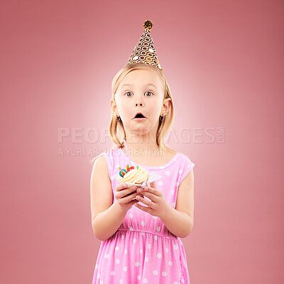 Buy stock photo Portrait, surprise and kid with cupcake at birthday in studio isolated on a pink background mockup space. Face, wow of child and cake at party in hat at celebration, food event and shocked at dessert