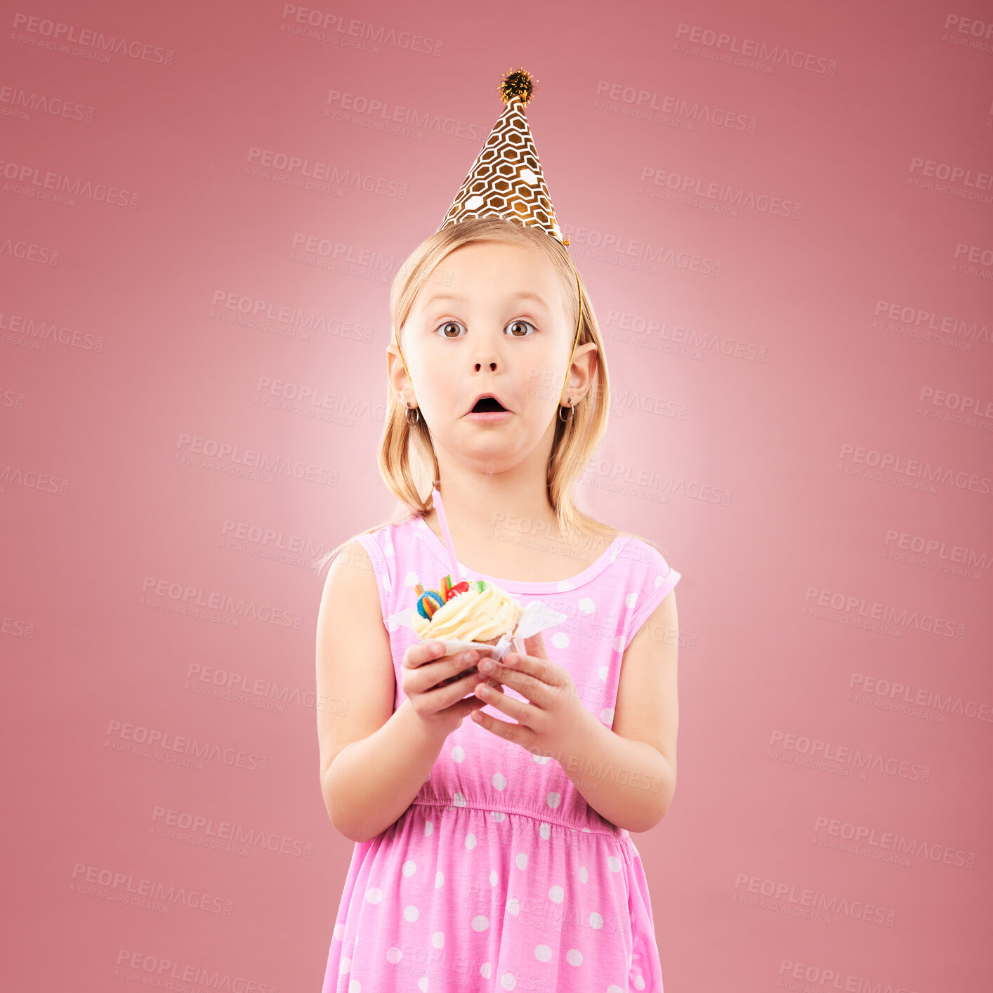 Buy stock photo Portrait, surprise and kid with cupcake at birthday in studio isolated on a pink background mockup space. Face, wow of child and cake at party in hat at celebration, food event and shocked at dessert