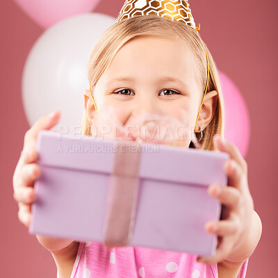 Birthday, gift and portrait of a child with balloons in studio for party, holiday or happy celebration. Face of excited girl kid on a pink background giving box, present or surprise package in hands