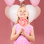 Balloons, lollipop and portrait of girl on pink background for birthday party, celebration and special day. Happy, excited and young cute child smile with candy, sweet treats and dessert in studio