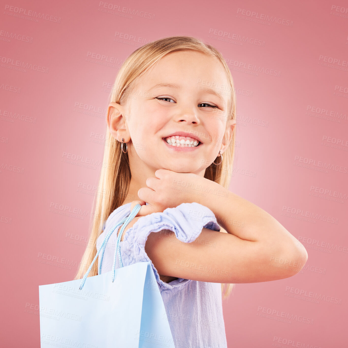 Buy stock photo Portrait, girl kid with shopping bag or gift, customer and purchase with fashion or birthday party on pink background. Retail, smile and child with present, luxury and event with happiness in studio