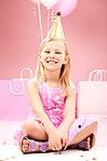 Balloons, birthday and portrait of child on pink background for party, celebration and special day. Happy, excited and young girl sitting with presents, gift box and decoration for event in studio