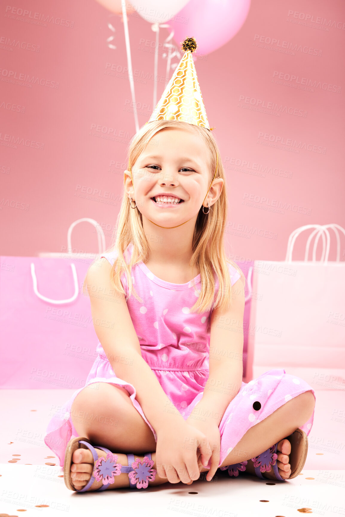 Buy stock photo Balloons, birthday and portrait of child on pink background for party, celebration and special day. Happy, excited and young girl sitting with presents, gift box and decoration for event in studio