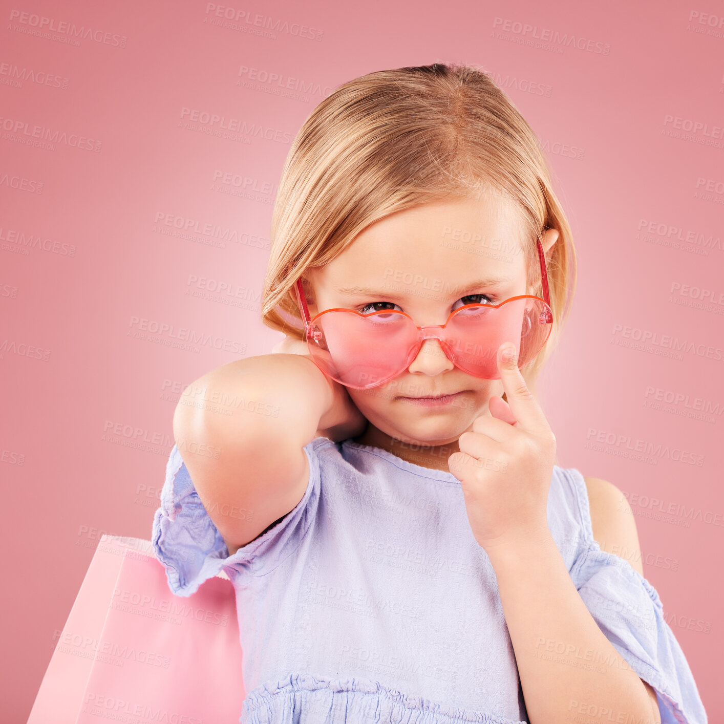 Buy stock photo Girl, kid and portrait, fashion sunglasses with shopping bag or gift with event isolated on pink background. Stylish, retro and accessory with funky outfit, present for party or retail in studio 