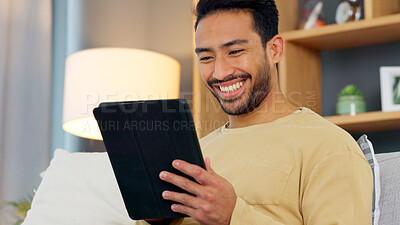 Buy stock photo Laugh, relax and asian man with a tablet a sofa for social media, chat or streaming at home. Digital, app and Japanese male in a living room smile for gif, meme or web, post and online communication