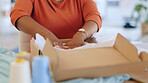 Black woman, hands and box in logistics for delivery, ecommerce or shipping cargo at office desk. Hand of African American female in small business packing product for shipment or courier service