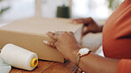 Black woman, hands and box in logistics for delivery, ecommerce or shipping cargo at office desk. Hand of African American female in small business packing product for shipment or courier service