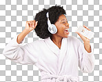 Black woman, music headphones and singing with phone in studio isolated on a yellow background. Karaoke singer, bathrobe and happy female dance with mobile microphone while streaming podcast or radio