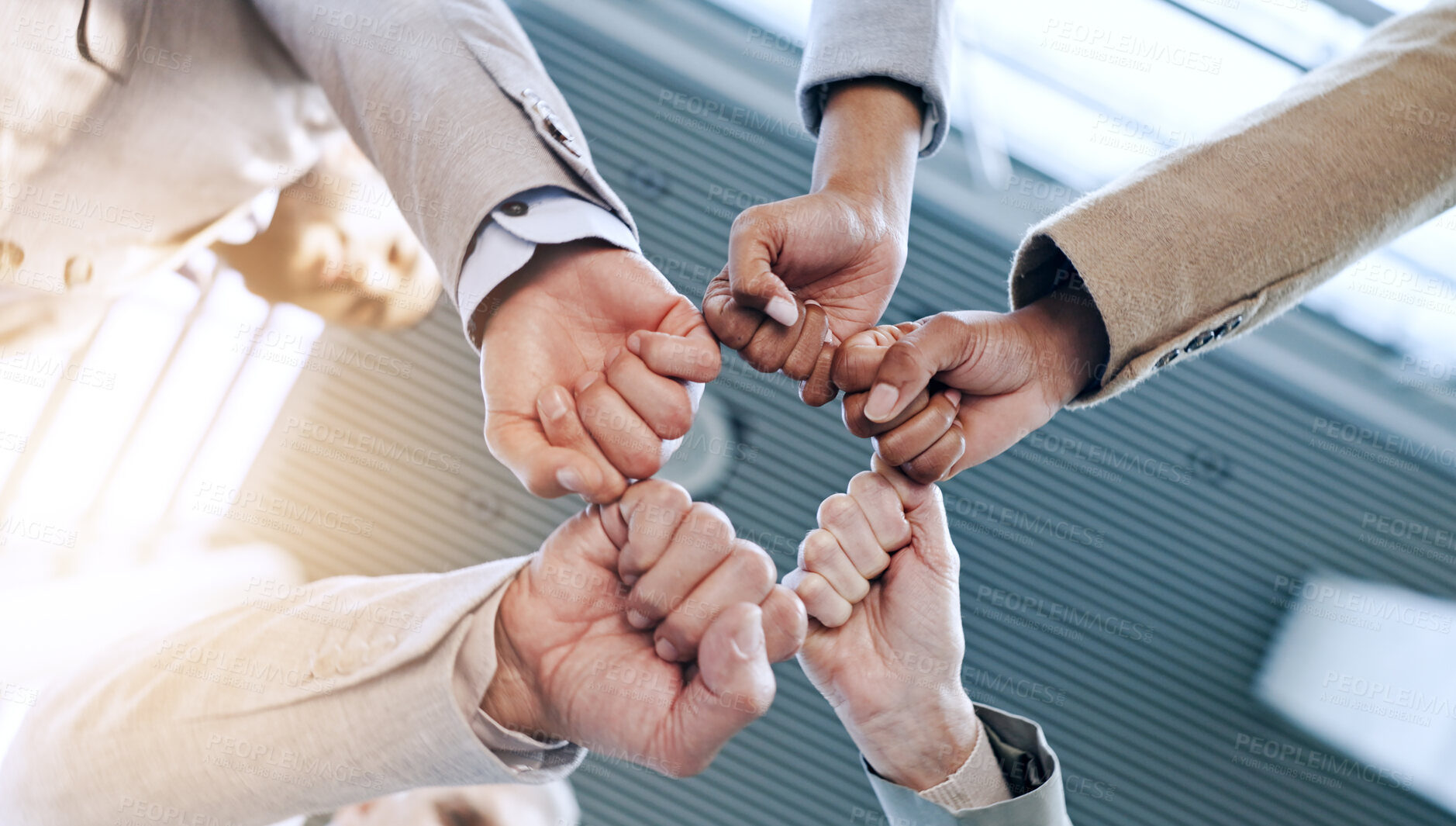 Buy stock photo Support, teamwork and business people with fist bump, huddle and motivation for employees, collaboration and goals. Team building, low angle and hands of colleagues, meeting and company solidarity