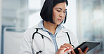 Woman, doctor and tablet for healthcare search, typing and clinic or hospital software, telehealth or research. Office, online charts or report of medical professional or asian person on digital tech