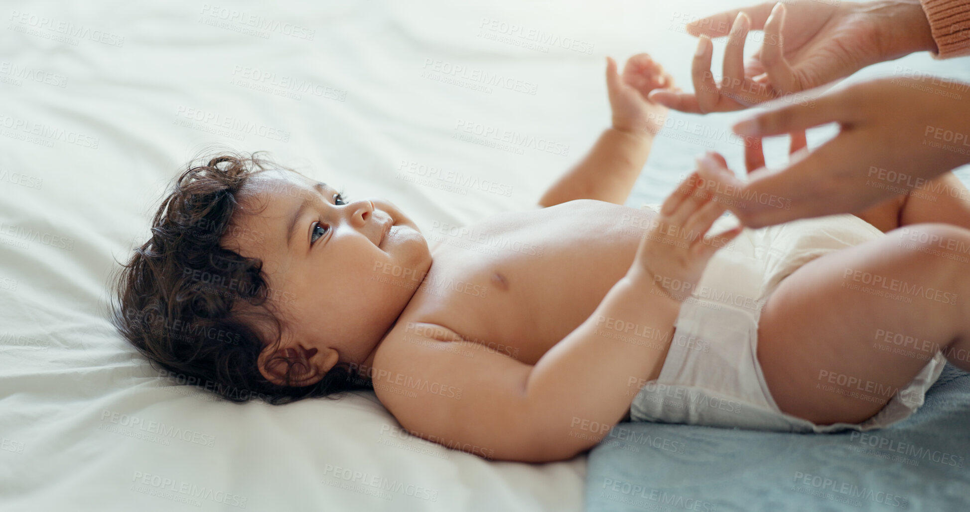 Buy stock photo Hands, love and a baby on a bed with a parent in the home together for trust, care or bonding closeup. Family, kids or security with an adult and infant child in the bedroom of a house for growth