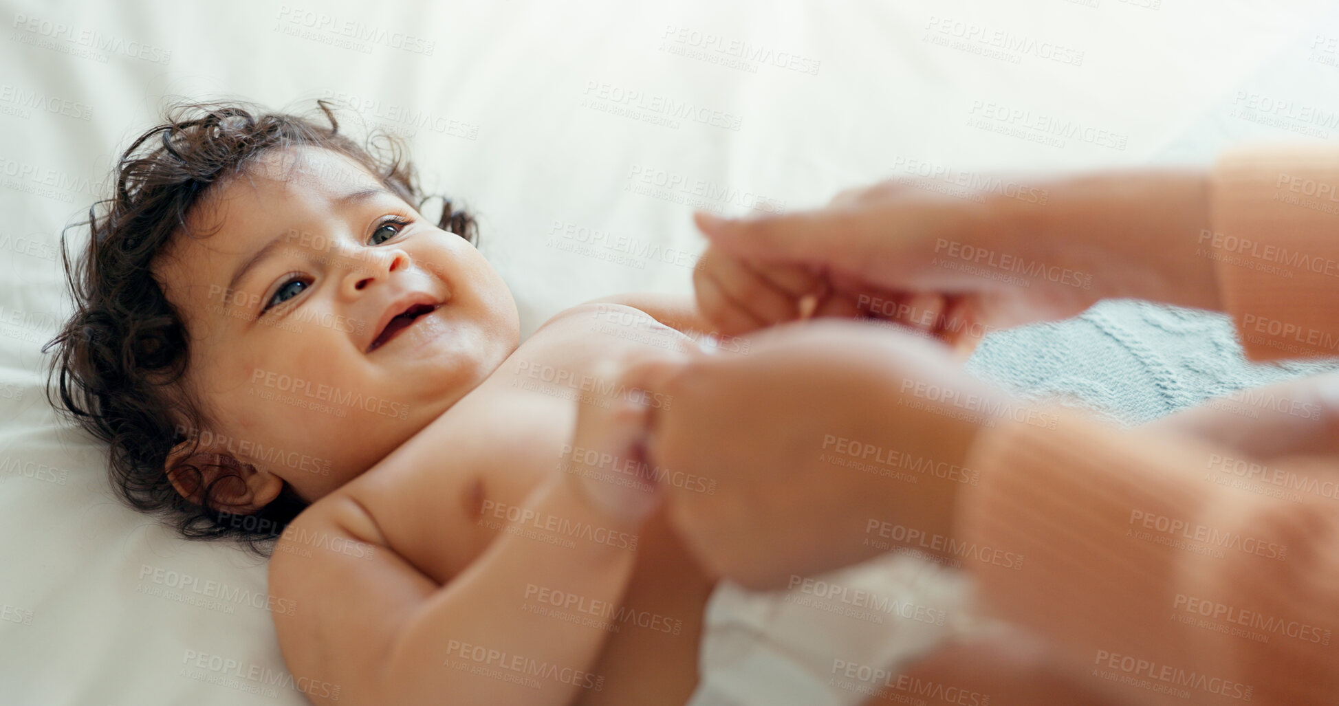 Buy stock photo Hands, growth and a baby on a bed with a parent in the home together for trust, care or bonding closeup. Family, kids or love with an adult and infant child in the bedroom of a house for growth